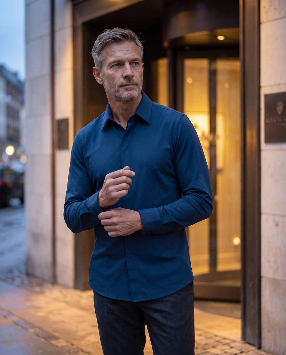 Mature man adjusting the cuff of the navy Alfonso shirt