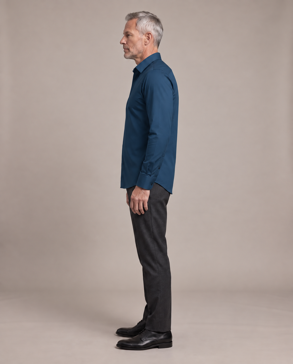Side view of a mature man wearing the navy Alfonso shirt